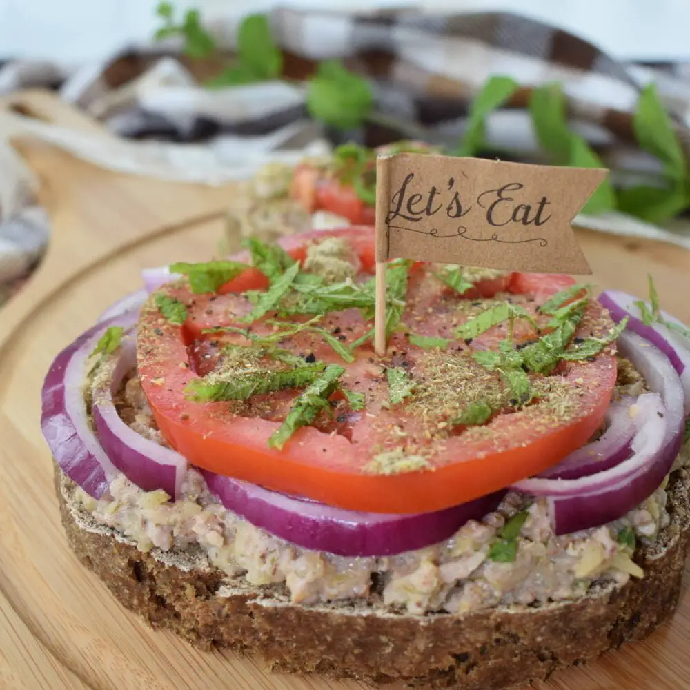 ¾ shot of a vegan sandwich with zucchini dip