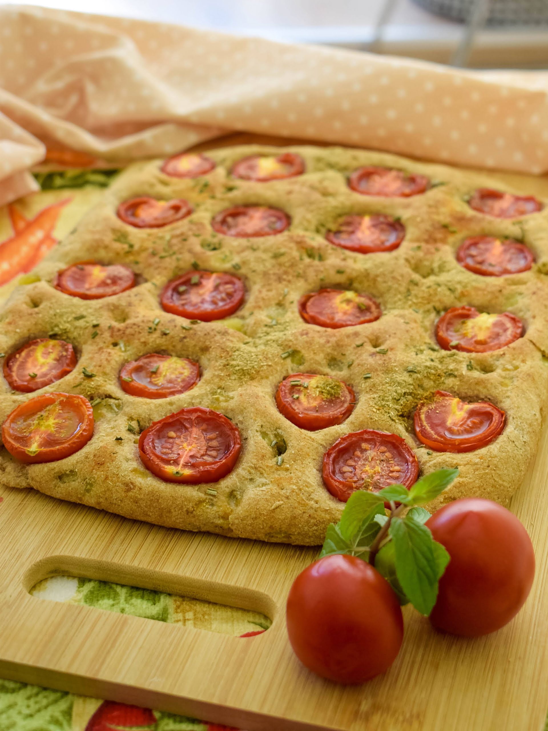Whole wheat potato focaccia with cherry tomatoes and rosemary