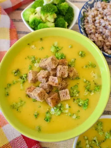 A bowl of vegan broccoli cream soup overhead view
