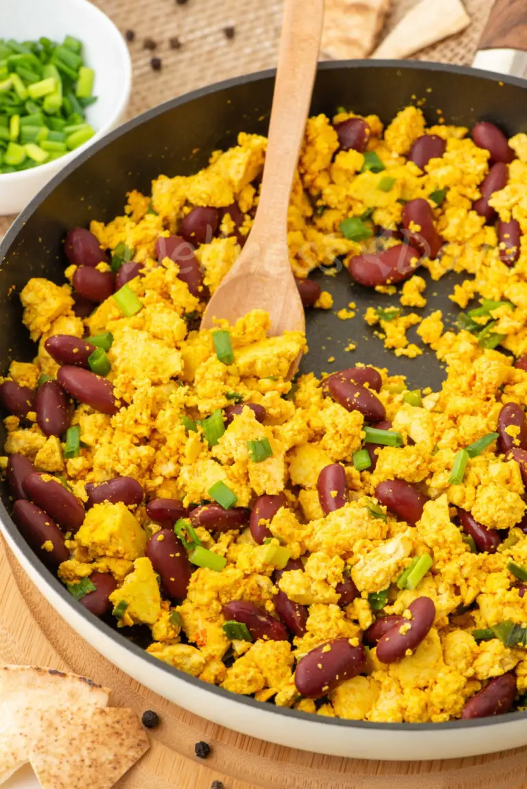 the tofu scramble, 3/4 angle, a wooden spoon taking some of it out