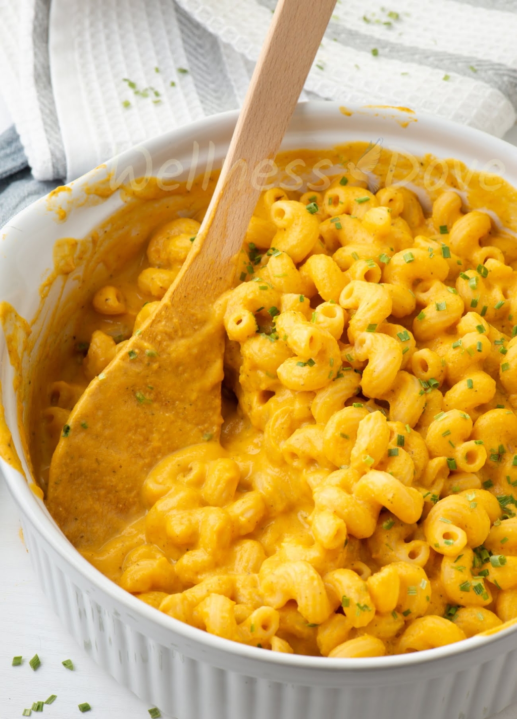 a casserole with vegan mac and cheese, with a spoon inside