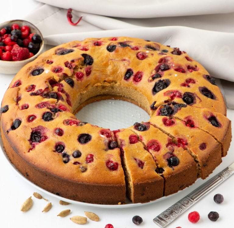 vegan berry bundt cake from 3.4 view, whole with some pieces cut