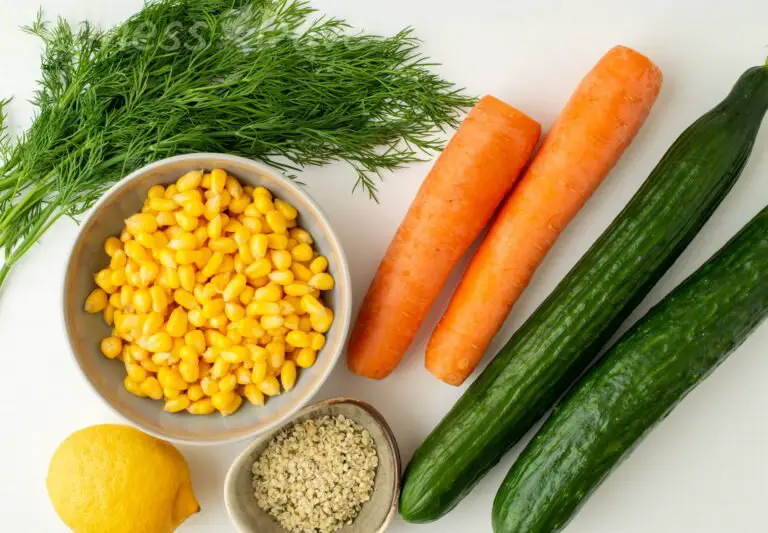 the ingredients for the cucumber carrot vegan salad: cucumber, carrot, corn, hemp seeds, lemon, dill