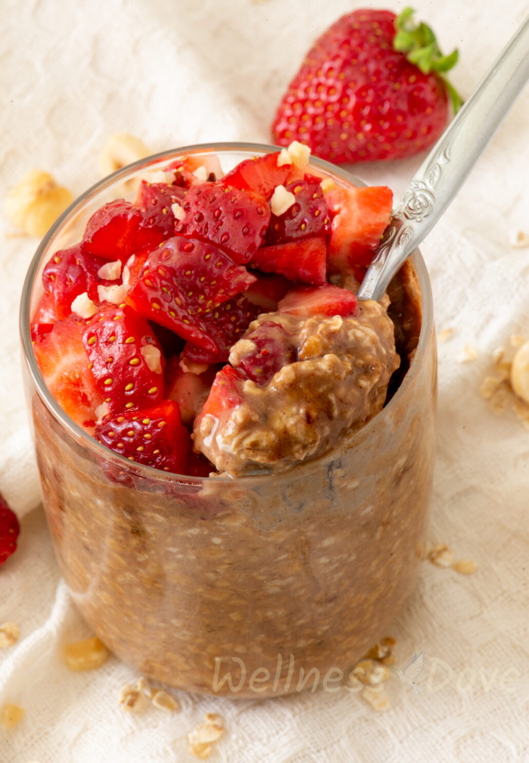 the vegan overnight oats in  glass with satrawberries