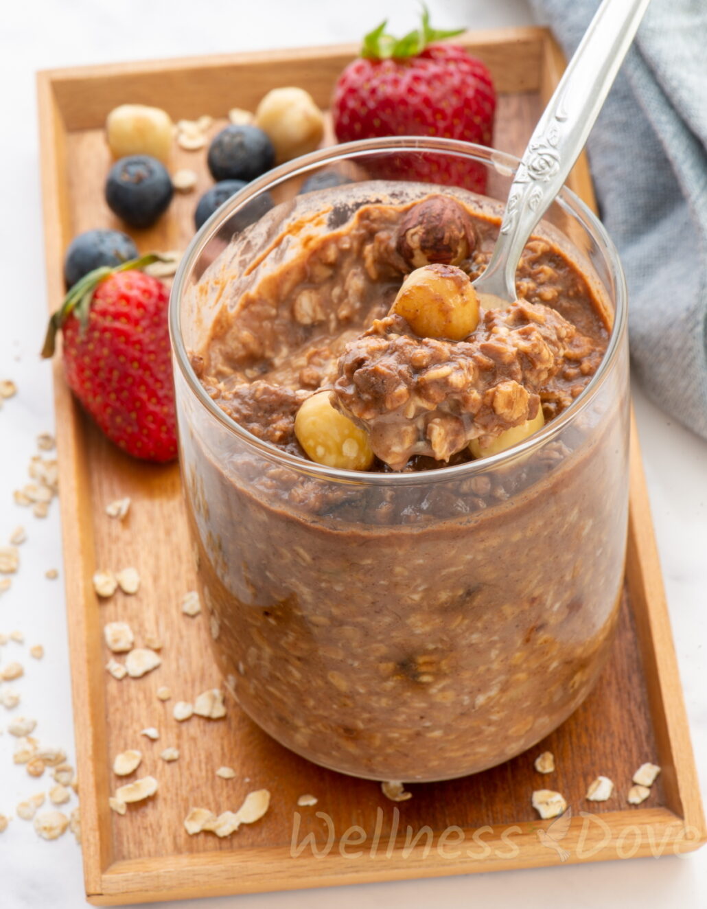 healthy overnight oats in  glass on a wooden tray