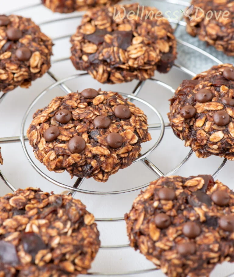 a close up image of the whole food vegan banana oatmeal breakfast cookies on a rack