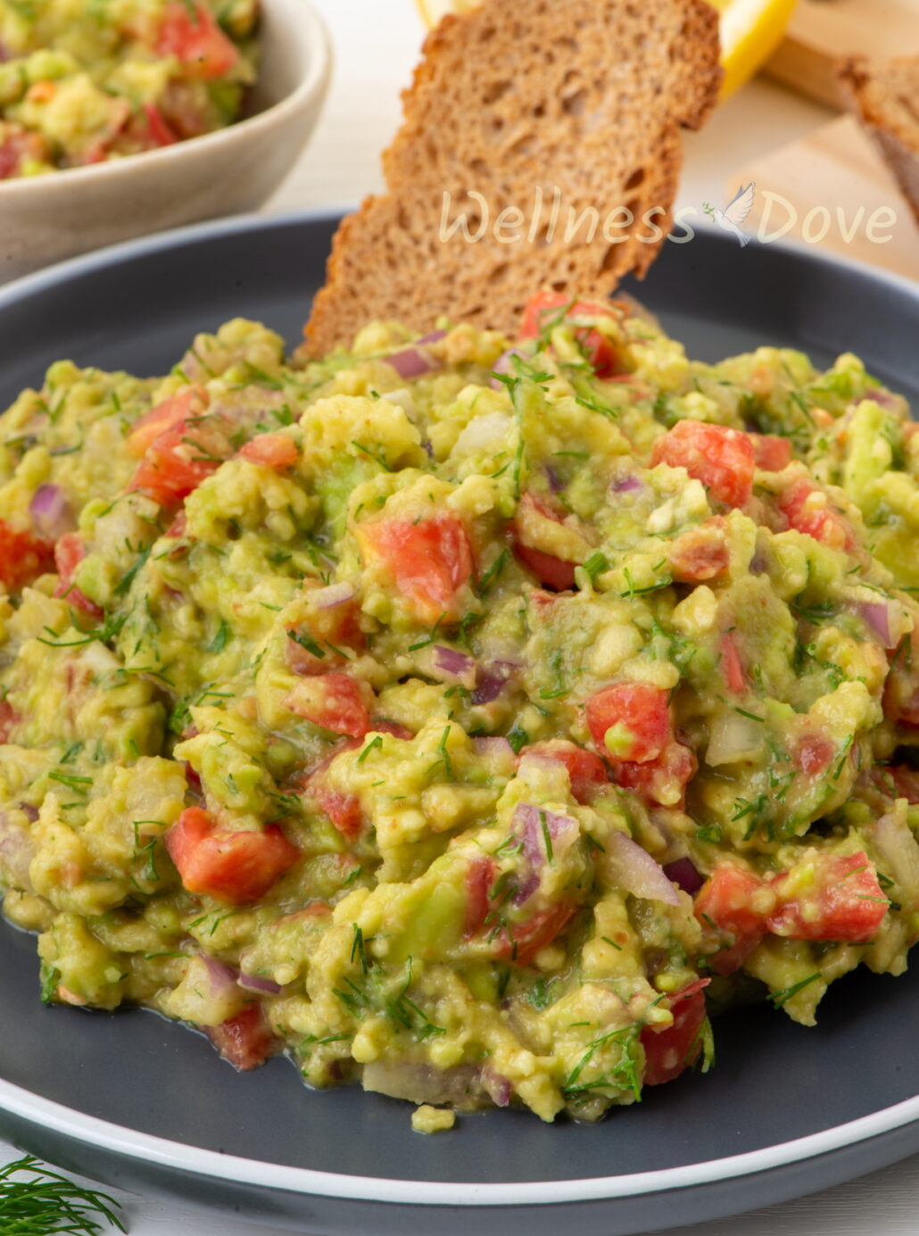 close up of the vegan homemade guacamole  in a black plate