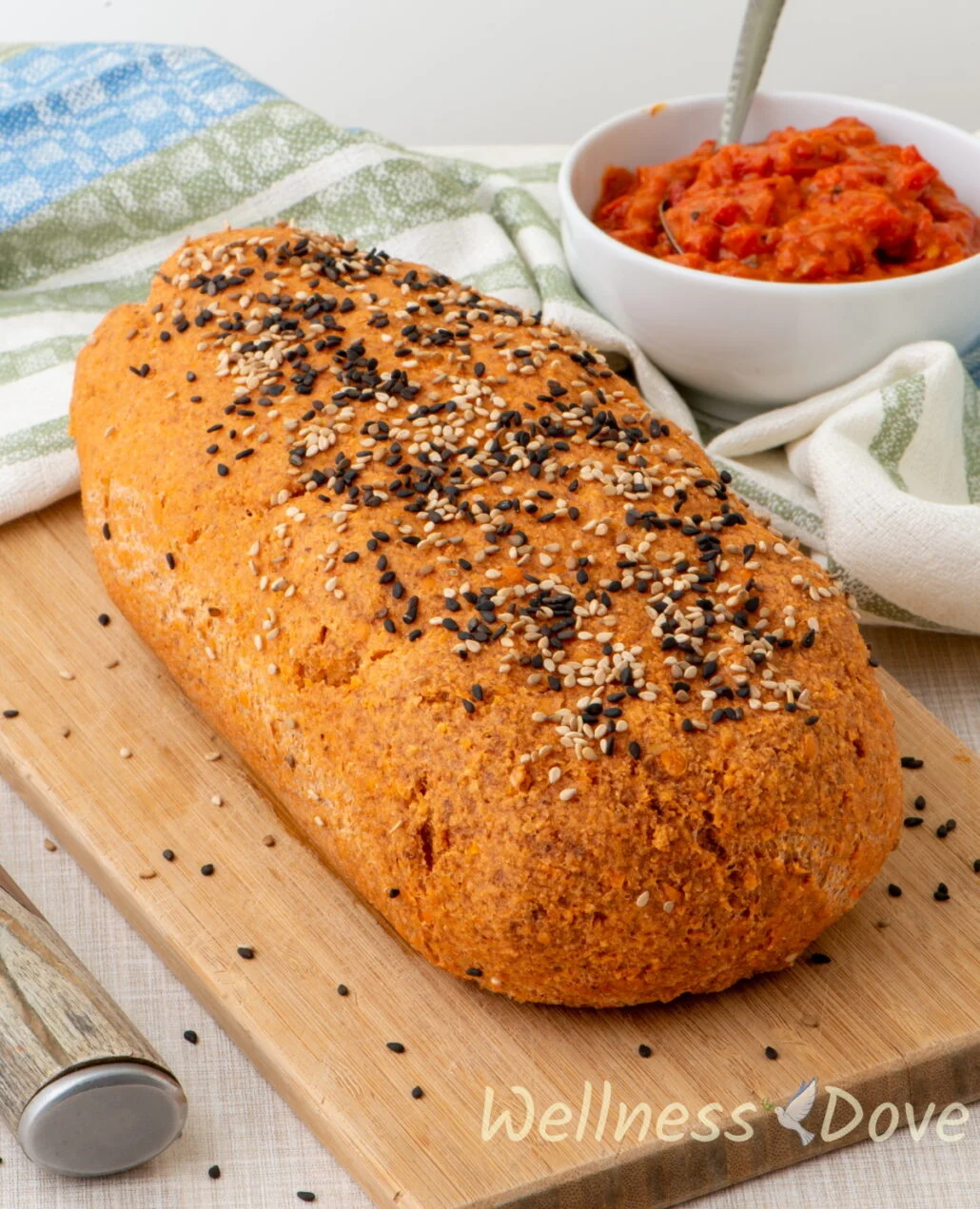 the whole vegan gluten free lentil bread on a chopping board 