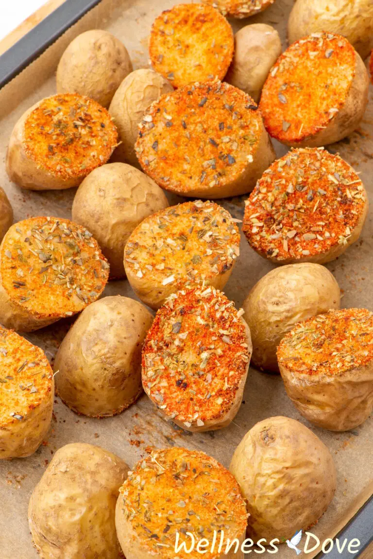 a close up view of the the vegan oven baked potatoes with herbs - 3/4 angle