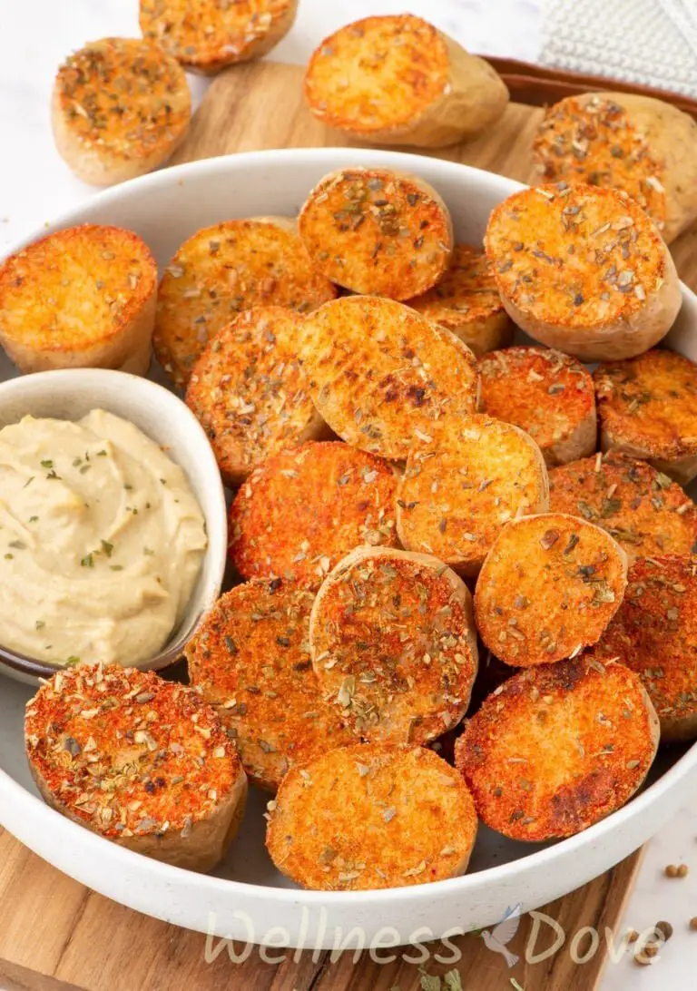 close up view of the the vegan oven baked potatoes with herbs in a bowl 