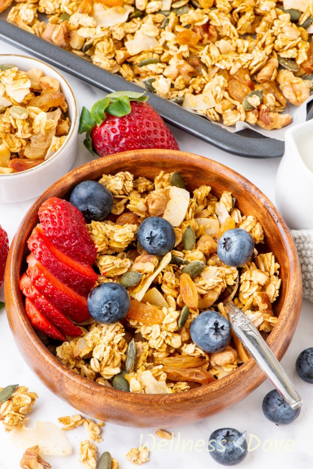 the homemade vegan sugar-free granola recipe in a wooden bowl from a 3/4 angle
