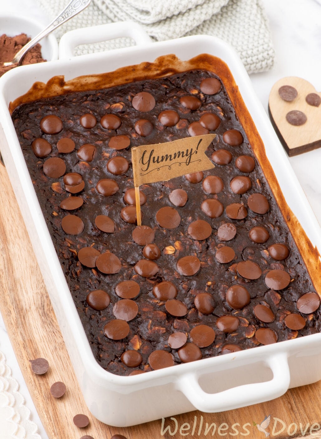 the Vegan Brownie Baked Oatmeal in a baking dish from a 3/4 view, with a small decorative flag in the middle