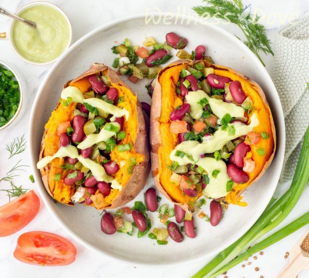 the bean stuffed vegan sweet potatoes in a large bowl, overhead shot
