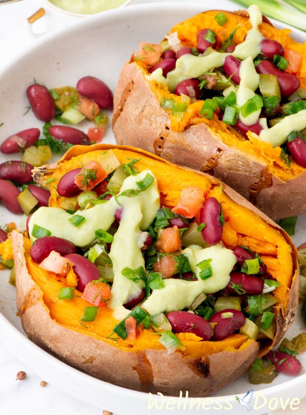 a macro shot of one of the bean stuffed vegan sweet potatoes on a chopping board