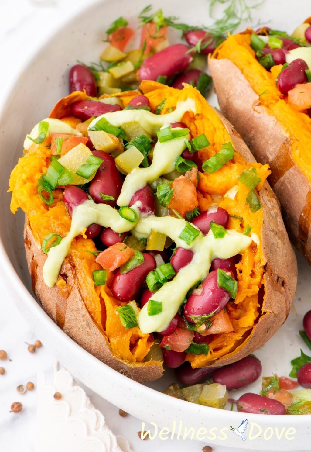 a macro shot of one of the bean stuffed vegan sweet potatoes in a large bowl