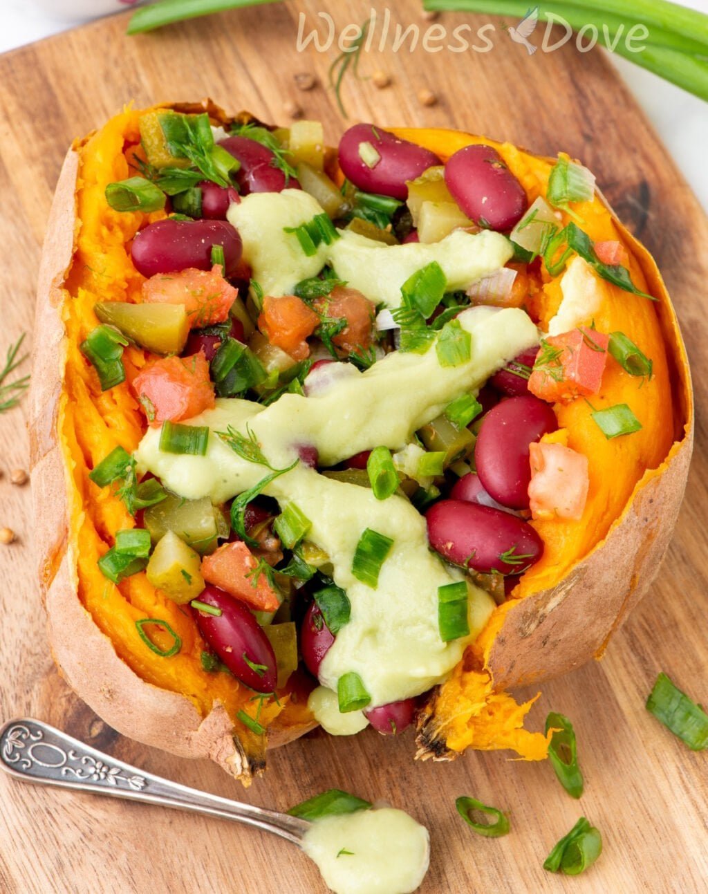 a macro shot of one of the bean stuffed vegan sweet potatoes on a chopping board