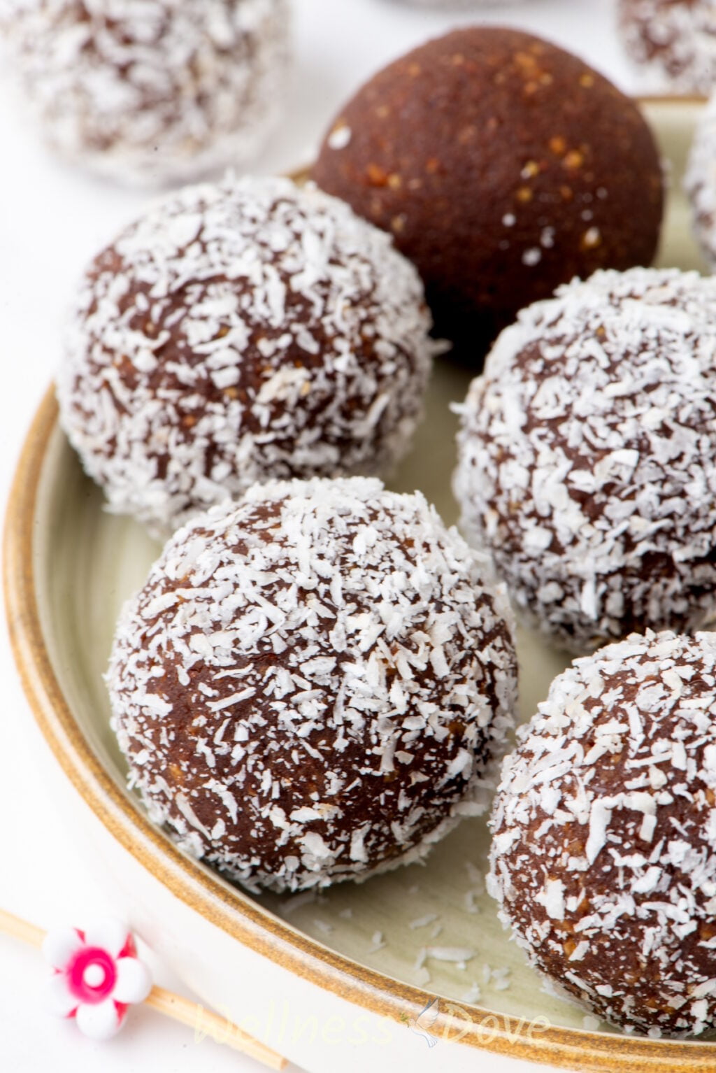 a close up view of the healthy vegan chickpea energy balls in a small plate