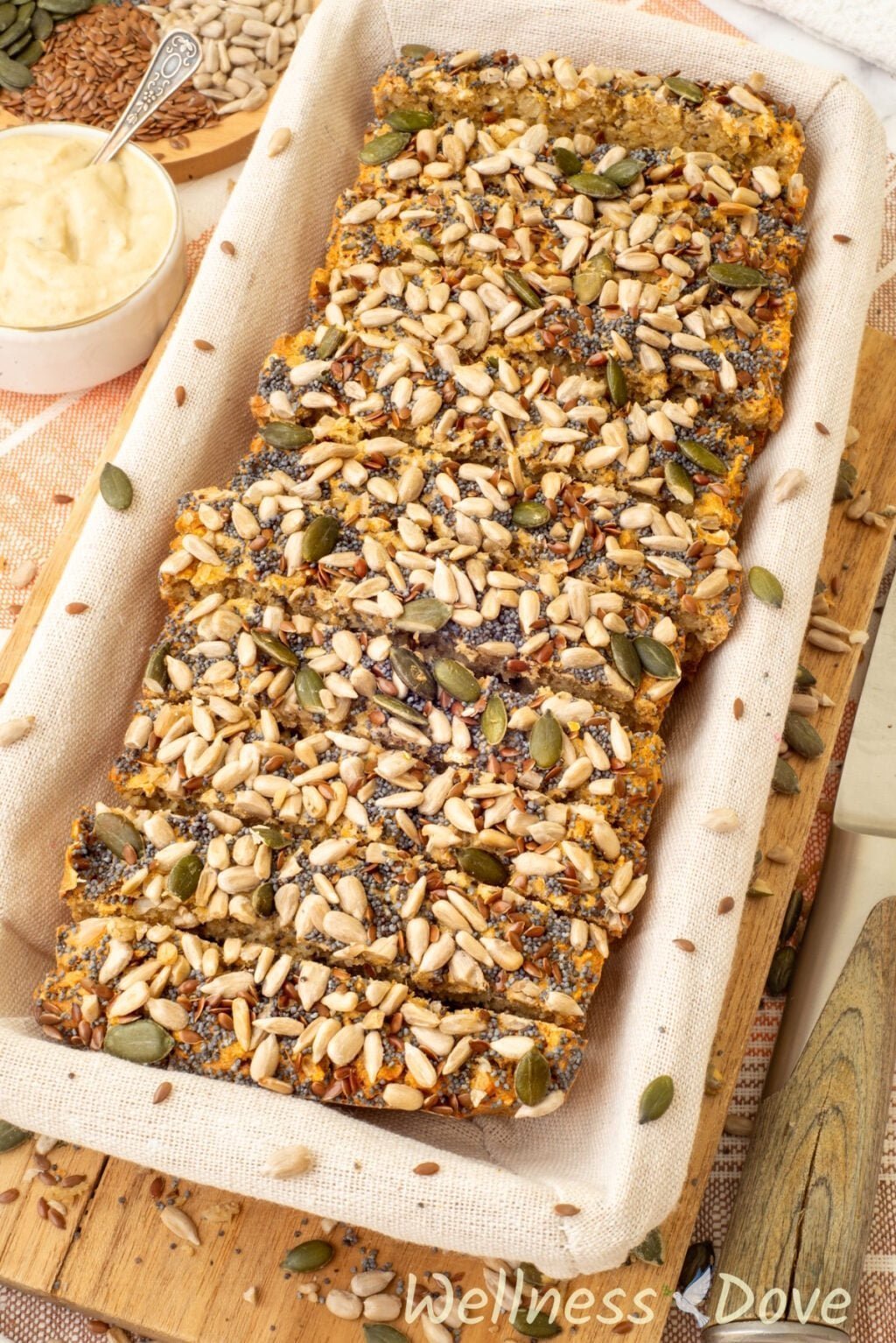 the Easy No Yeast Gluten free Vegan Quinoa Bread in a bread basket, sliced and shot from a 3/4 angle 