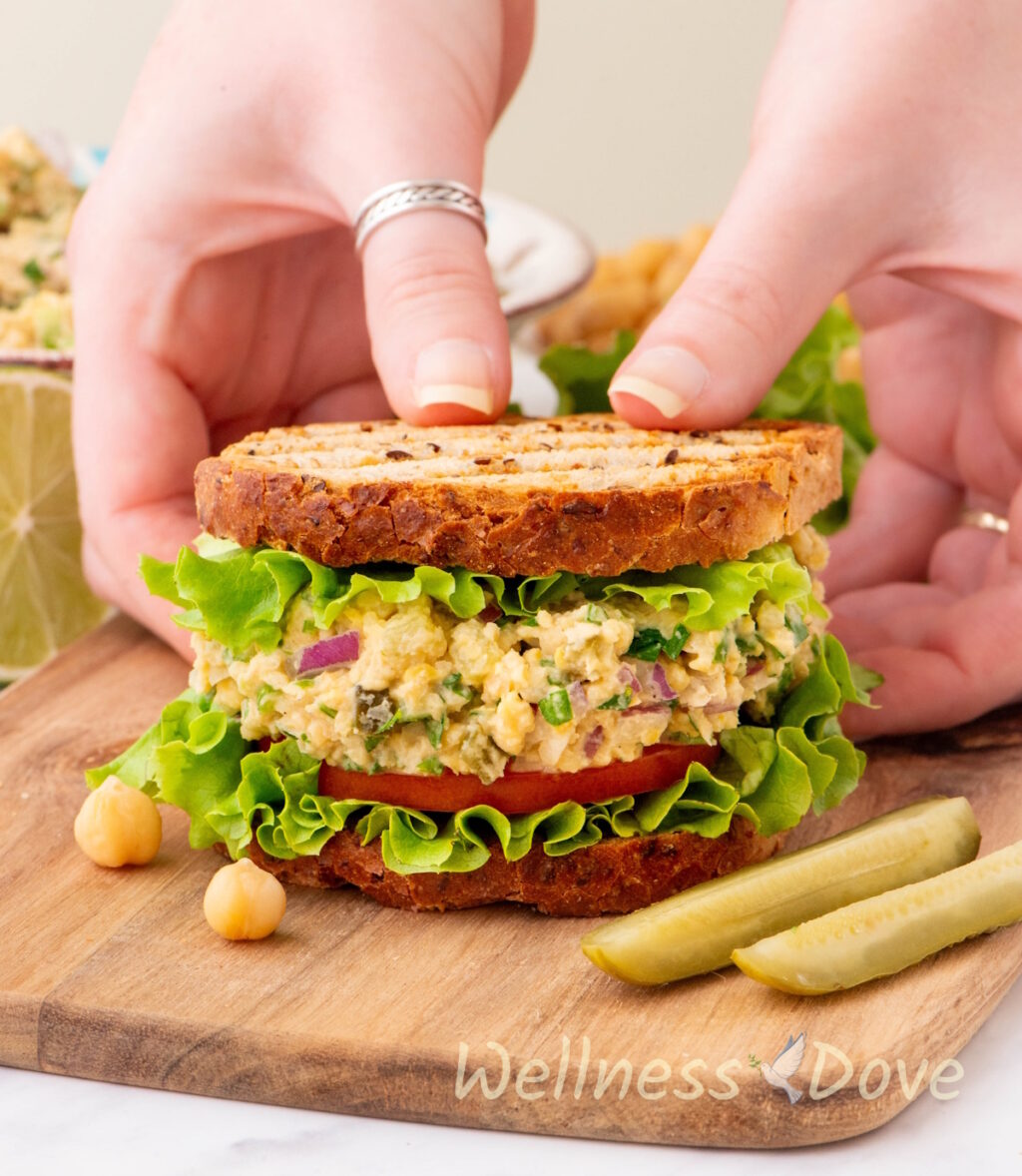 two hands are serving the  Healthy Vegan Chickpea ‘Tuna’ Salad