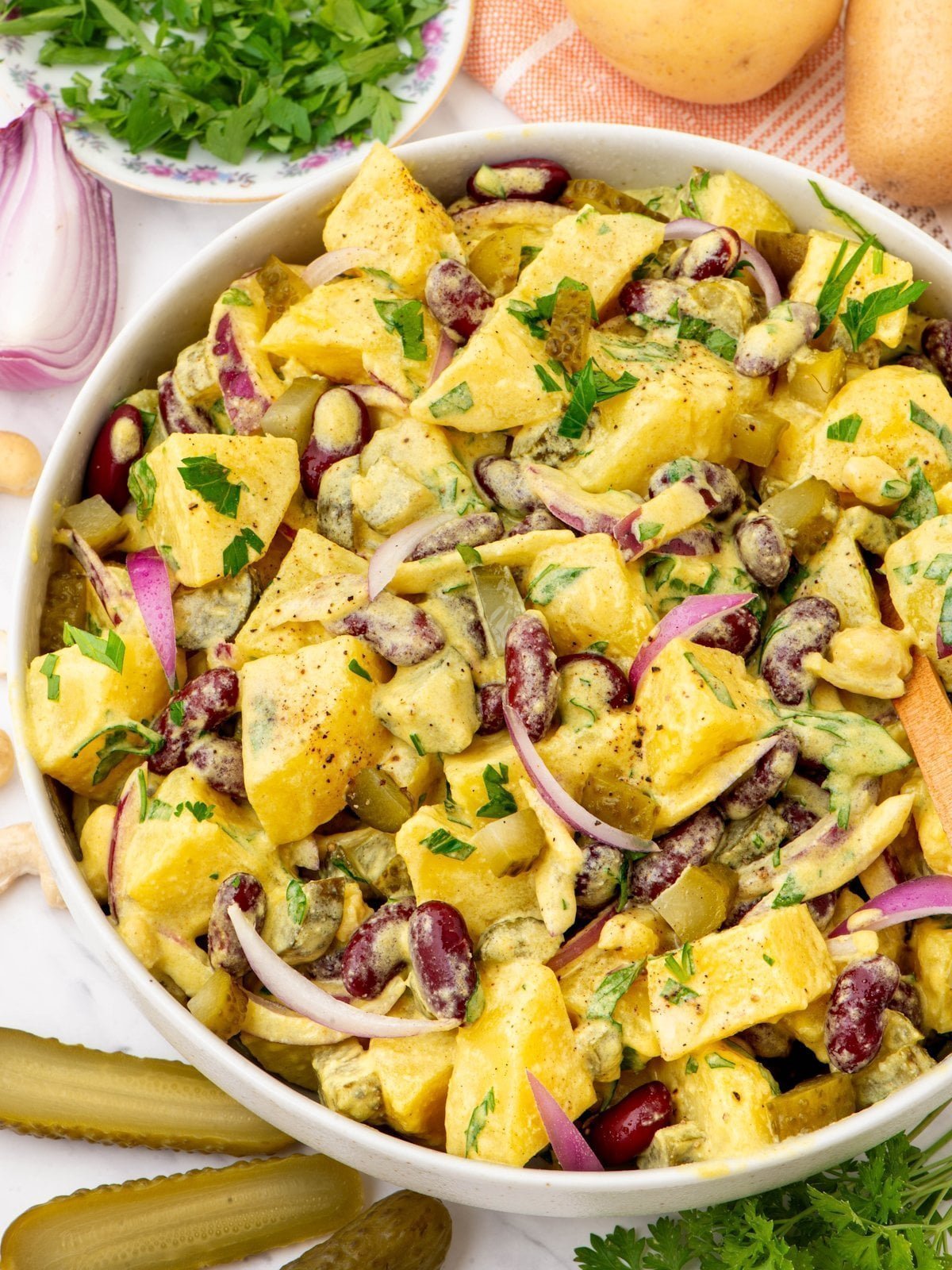 Creamy vegan potato salad with kidney beans and pickles