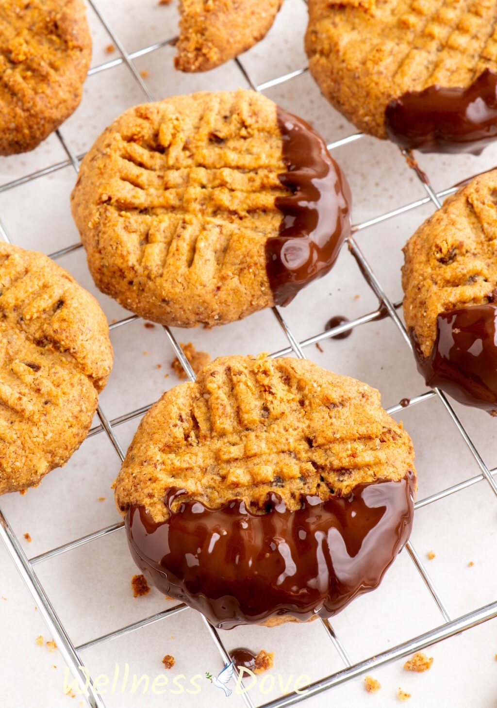 the Easy and Healthy Peanut Butter Vegan Cookies on a rack, some have been dipped in chocolate.